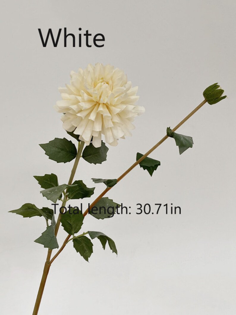 May include: A single white artificial dahlia flower stem with green leaves. The stem is 30.71 inches long.  The flower is a cream color and has a layered, ruffled appearance.  The stem has a bud at the top.
