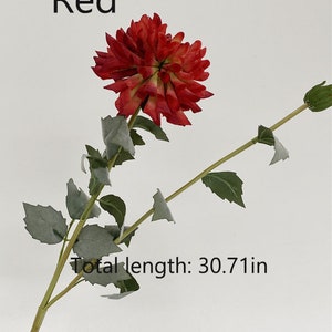 May include: A single red artificial flower stem with green leaves. The flower is a dahlia with a layered, ruffled appearance. The stem is approximately 30.71 inches long.