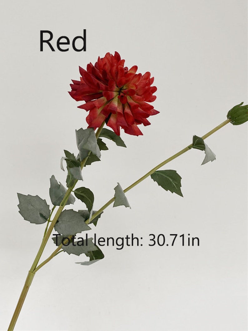 May include: A single red artificial flower stem with green leaves. The flower is a dahlia with a layered, ruffled appearance. The stem is approximately 30.71 inches long.
