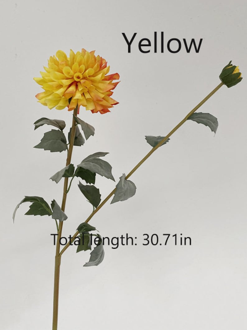 May include: A single artificial yellow and orange dahlia flower stem with green leaves. The stem is 30.71 inches long. The text "Yellow" is written above the flower and the text "Total Length: 30.71 in" is written below the flower.