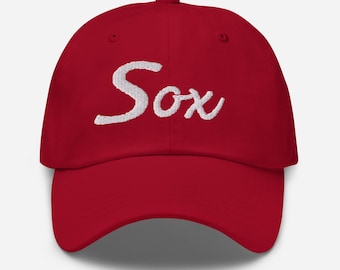 May include: A red baseball cap with white embroidered text that says "Sox".