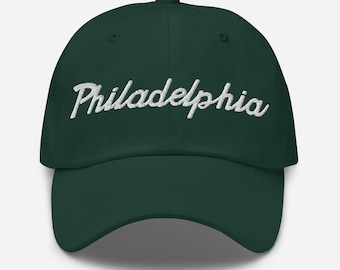 May include: A dark green baseball cap with white embroidered text that reads "Philadelphia".