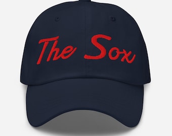 May include: A navy blue baseball cap with red embroidered text that reads "The Sox".