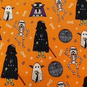 May include: Orange fabric with a repeating pattern of Halloween characters from Star Wars. The characters include Darth Vader, Yoda, Stormtroopers, and ghosts. The fabric is perfect for crafting projects like costumes, bags, and home decor.