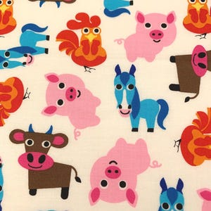 May include: A cream-colored fabric featuring a repeating pattern of cartoon farm animals. The print includes brown cows with pink snouts, bright blue horses, pink pigs with curly tails, and orange and red roosters, all arranged in a scattered layout.