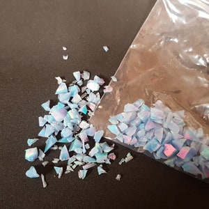 2 grams crushed synthetic opal. Light blue with green,pink and orange.
