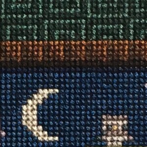 May include: Close-up of a blue and white fabric with a crescent moon design. The fabric has a textured, woven appearance.