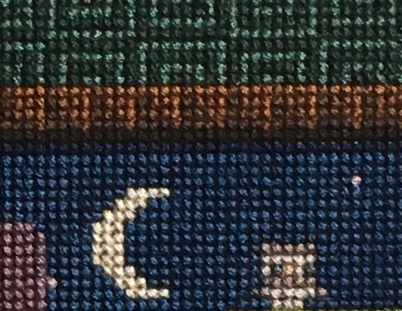 May include: Close-up of a blue and white fabric with a crescent moon design. The fabric has a textured, woven appearance.