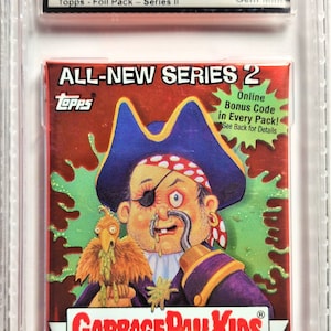 May include: A graded, unopened 2004 Garbage Pail Kids Series II sticker pack. The pack features a cartoon pirate with an eye patch and a parrot. The packaging includes the text "ALL-NEW SERIES 2" and "GROSS STICKERS". The grade is 9.5 Gem Mint.