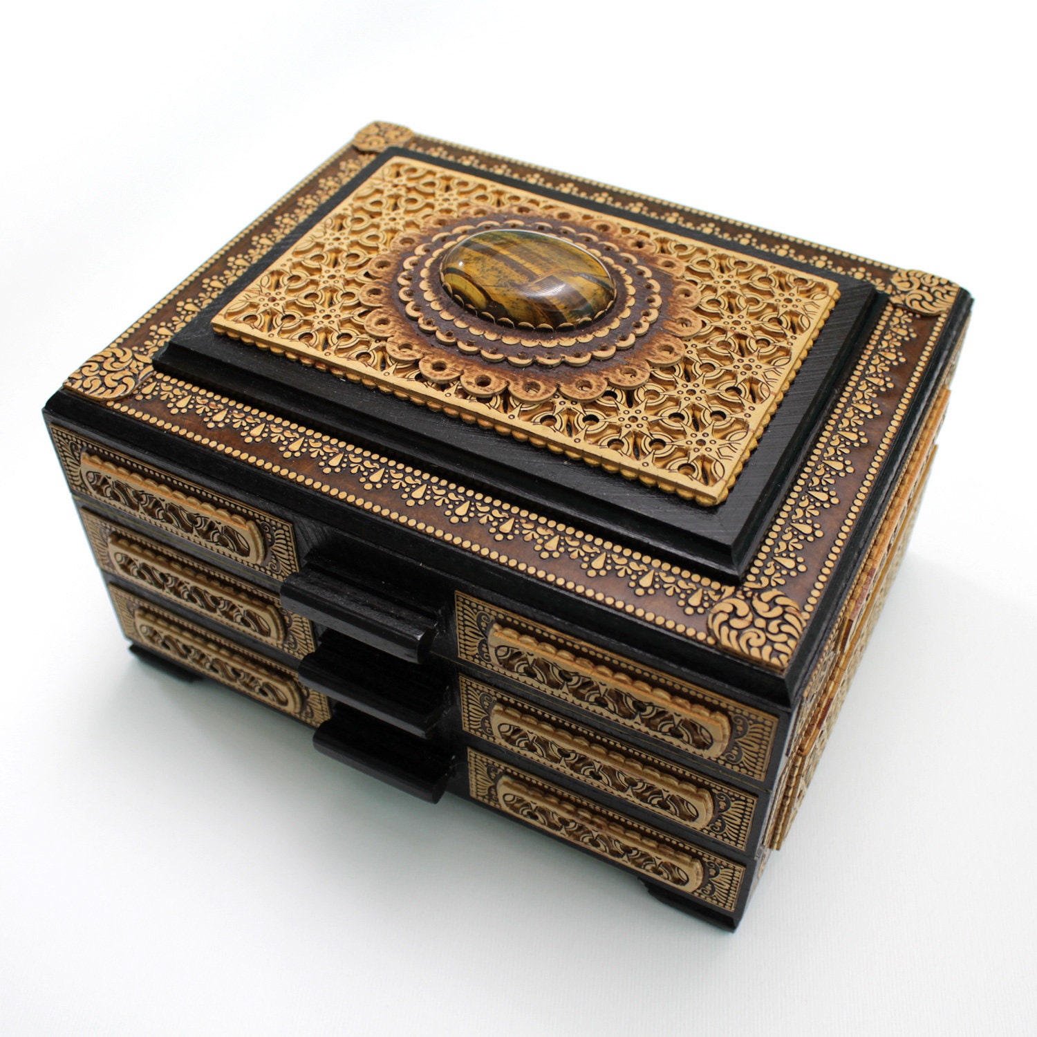 Miniature chest of drawers for jewelry inlaid with carved birch bark and natural stone Tiger's Eyes. Has three pull-out tiers, velvet inside