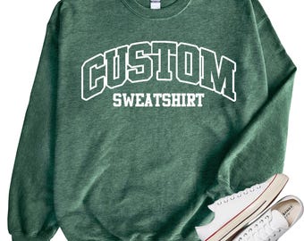 May include: A green sweatshirt with the text "CUSTOM SWEATSHIRT" in white letters.