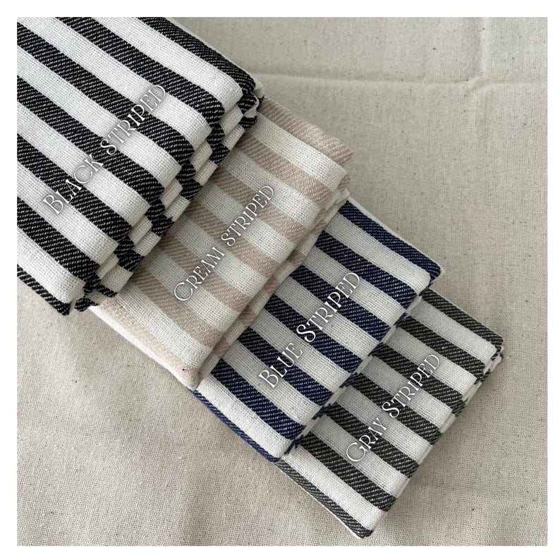 May include: Four fabric swatches with different colored stripes. The swatches are labeled "Black Striped", "Cream Striped", "Blue Striped", and "Gray Striped".