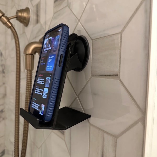 Phone holder for shower, mirror or any non pores surface. Mechanical actuated suction cup for better grip