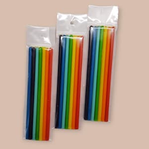 May include: Three packages of colorful, rainbow-striped craft sticks. Each package contains a bundle of straight, thin sticks in a variety of colors, including red, orange, yellow, green, blue, and black. The sticks are packaged in clear plastic bags.