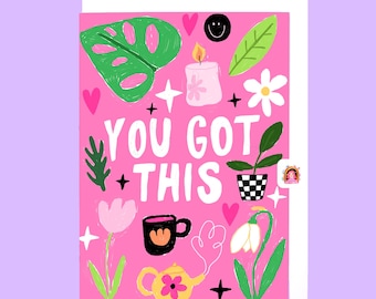 May include: Pink card with the text "You Got This" in white. The card is decorated with illustrations of flowers, a candle, a teapot, a mug, and a potted plant.