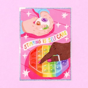 May include: Two hands, one with light skin and one with dark skin, are shown engaging in stimming activities. One hand is holding a multi-colored fidget toy, while the other hand is pressing down on a rainbow pop-it fidget toy. The background is pink with white stars. The text "Stimming is Self Care" is written in a white banner.