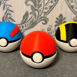 May include: Three Poke Balls, one red, one blue with a red stripe, and one black with a yellow stripe.