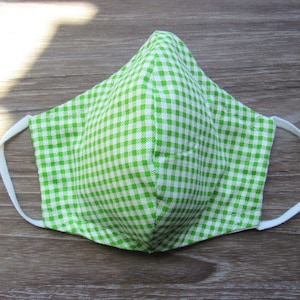 May include: A green and white gingham face mask with white elastic ear loops.