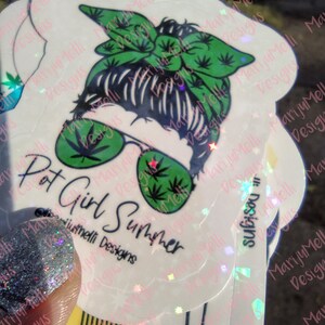 May include: A white sticker with a cartoon illustration of a person wearing sunglasses and a green bandana with a marijuana leaf design. The text "Pot Girl Summer" is written below the illustration. The sticker is on a holographic background.