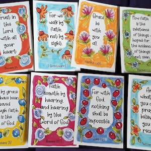 May include: Set of 8 colorful cards with inspirational quotes and bible verses. Each card features a different floral design and a verse from the Bible. The cards are perfect for adding a touch of faith and inspiration to your home or office.