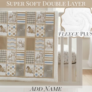May include: A rectangular baby blanket with a patchwork design featuring Winnie the Pooh and Eeyore illustrations, blue and brown stripes, gingham checks, and polka dots. The blanket includes the name Liam and has a white fleece plush border.