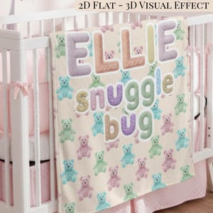 May include: A personalised baby blanket with the name "ELLIE" in large, textured letters. The blanket features the words "snuggle bug" and is decorated with colourful teddy bears in pastel shades of blue, green, and pink. The blanket is draped over a white cot.