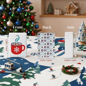 May include: A rectangular mahjong tile showing a red mug with a white snowflake and steam on the front, a geometric holiday pattern on the back, and a plain white side. Dimensions are 1.42 inches high, 1.02 inches wide, and 0.63 inches deep.