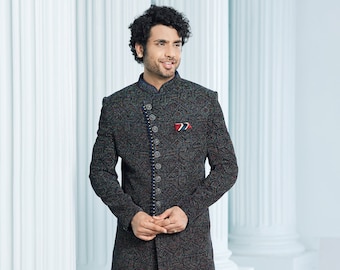 May include: A black patterned long-sleeved jacket with a mandarin collar and silver buttons. The jacket is worn over black pants and black shoes.