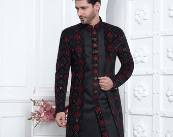 May include: A black long-sleeved kurta with a maroon and black geometric pattern. The kurta has a mandarin collar and a button closure. The model is wearing black pants and black shoes. D.NO. 2772