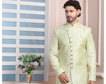 Könnte beinhalten: Hellgrüner bestickter Sherwani-Anzug mit Rautenmuster, kombiniert mit einer weißen Hose. Die langärmlige Jacke hat einen Stehkragen und dekorative Knöpfe. Das Outfit wird mit weißen Schuhen getragen.