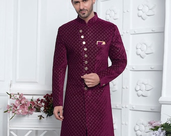 May include: A maroon velvet long-sleeved kurta with a mandarin collar and gold buttons. The kurta has a subtle floral pattern and is paired with white trousers. D.NO. 2774