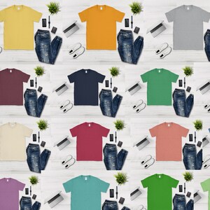 May include: A collection of 12 plain t-shirts in various colors, including yellow, orange, gray, maroon, navy blue, green, beige, red, coral, purple, teal, and lime green. Each t-shirt is laid flat on a white wooden surface with a pair of white sneakers, a laptop, a pair of jeans, a watch, and a phone beside it.