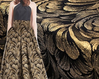 May include: Black fabric with a gold floral pattern. The fabric has a subtle sheen and a textured surface.