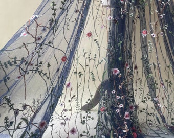 May include: Navy blue tulle fabric with embroidered floral designs in shades of pink, red, and green.