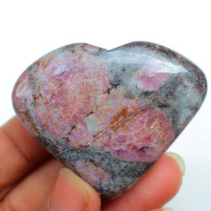 May include: A heart-shaped pink and grey gemstone with a rough, natural texture.
