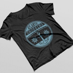 May include: Black t-shirt with a blue and white logo that says "Atlantic Crossing International Sailing Club" with an anchor and two steering wheels.