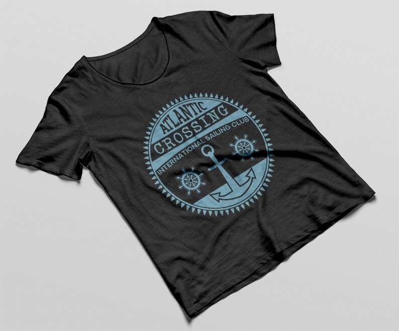 May include: Black t-shirt with a blue and white logo that says "Atlantic Crossing International Sailing Club" with an anchor and two steering wheels.