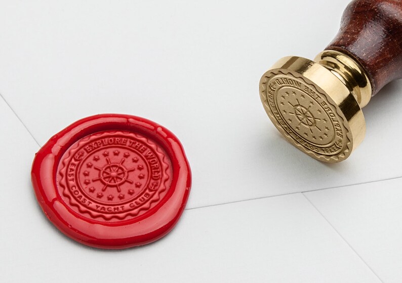 May include: A red wax seal with the text "East Coast Yacht Club Explore the World" and a nautical wheel design.