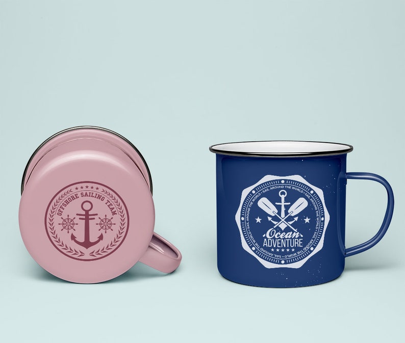 May include: Two enamel mugs with nautical designs. The pink mug has a white anchor and the text "Offshore Sailing Team". The blue mug has a white anchor and paddles with the text "Ocean Adventure".
