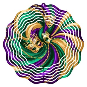 May include: A metal wind spinner with a swirling design of gold, green, and purple. The design features two masquerade masks with gold accents.
