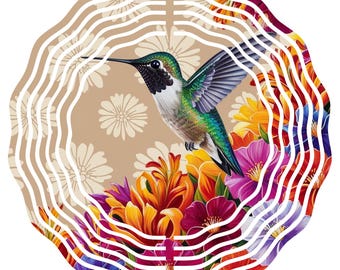 May include: A metal wind spinner with a hummingbird design. The hummingbird has green, blue, and black feathers, set against a backdrop of colorful flowers. The spinner has a wavy, layered design, with a tan background and white floral patterns.