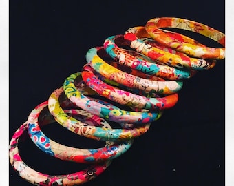 Unique costume jewelry, colorful bracelets made with tissue paper on wooden support, artisanal creation