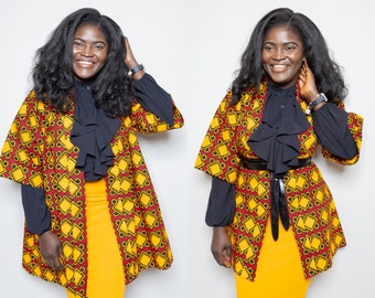 May include: A woman wearing a yellow and red patterned kimono with a black ruffled blouse and a yellow skirt.