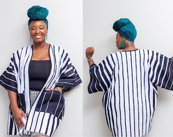 May include: A black and white striped kimono with a teal head wrap. The kimono has a long, loose fit and is made of a lightweight fabric.