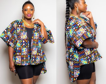 May include: A colourful patterned kimono with a brown background and geometric shapes in blue, yellow, orange, and white. The kimono has a long, flowing design and is open at the front.