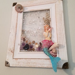 Mermaid Calling.  Sweet Mermaid is calling you from under the sea.   This pretty pink and teal mermaid is set upon a grouping of shells