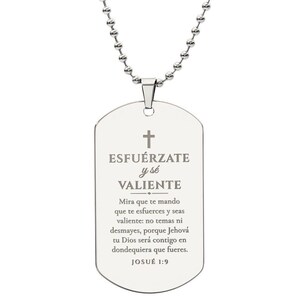 May include: A silver-toned metal dog tag pendant suspended from a matching ball chain. The pendant features an engraved cross and the Spanish text ESFUÉRZATE y sé VALIENTE, followed by the full biblical verse from JOSUÉ 1:9.