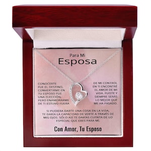 May include: A silver-toned heart-shaped pendant necklace with a central round stone, presented in a dark wood box. The card inside features the text Para Mi Esposa, a Spanish message about love, and the closing signature Con Amor, Tu Esposo.
