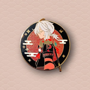 May include: A gold-colored enamel pin featuring a white-haired character with a red and black outfit, standing against a red and gold background with a cloud design. The character is holding a sword.