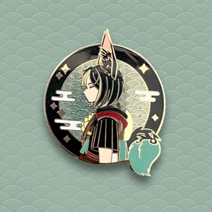 May include: A gold-toned enamel pin featuring a character with black hair and a fox tail. The character is wearing a black and gold robe with a red collar. The pin is set against a blue and gold background with a cloud design.